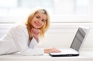 Beautiful business lady typing on a laptop computer.
